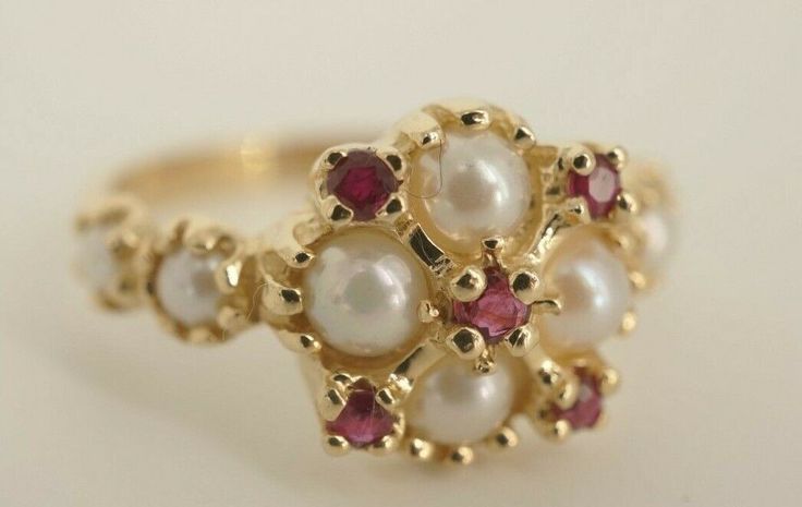 This is a very beautiful 14k yellow gold ring with 8 beautiful pearls and 5 ruby's. The ring is a size 7.25 and is 11mm wide at the top. The 4 pearls on the top of the ring are each approximately 4mm in diameter. The 4 on the side of the band are each 2.85mm. Also on the top of the ring are 5 ruby's that come to approximately 0.25ct. This a very beautiful and elegant ring that you will absolutely love!  Guaranteed to be 100% authentic.  DO NOT MISS OUT ON THESE BEAUTIFUL RINGS AND OTHER FINE JEW Pearl Rings Vintage Antique, Elegant Multi-stone Cluster Ring In Round Cut, Elegant Cluster Ring With 17 Jewels For Promise, Elegant Multi-stone Cluster Ring, Fine Jewelry Rings For Anniversary With Jewels, Elegant Multi-stone Cluster Ring With Round Cut, Fine Jewelry Rings For Anniversary, Anniversary Fine Jewelry Rings With Jewels, Vintage Wedding Rings With Jewels