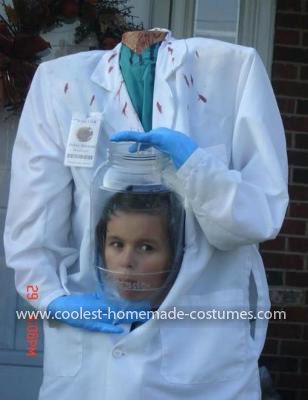 a man in a white lab coat and blue gloves is holding a jar with something on it