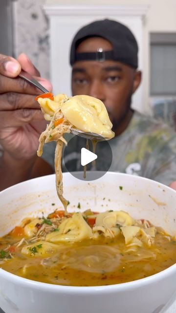 a man is holding a ladle full of soup and dumpling it into a bowl