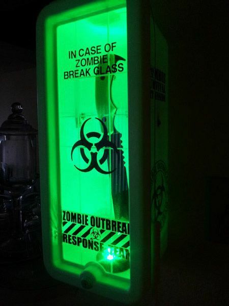 a green light up box with some type of zombie sign on it's side