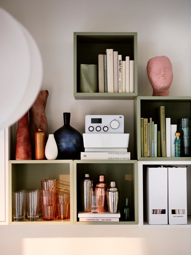 the shelves are filled with books, vases and other decorative items on top of them