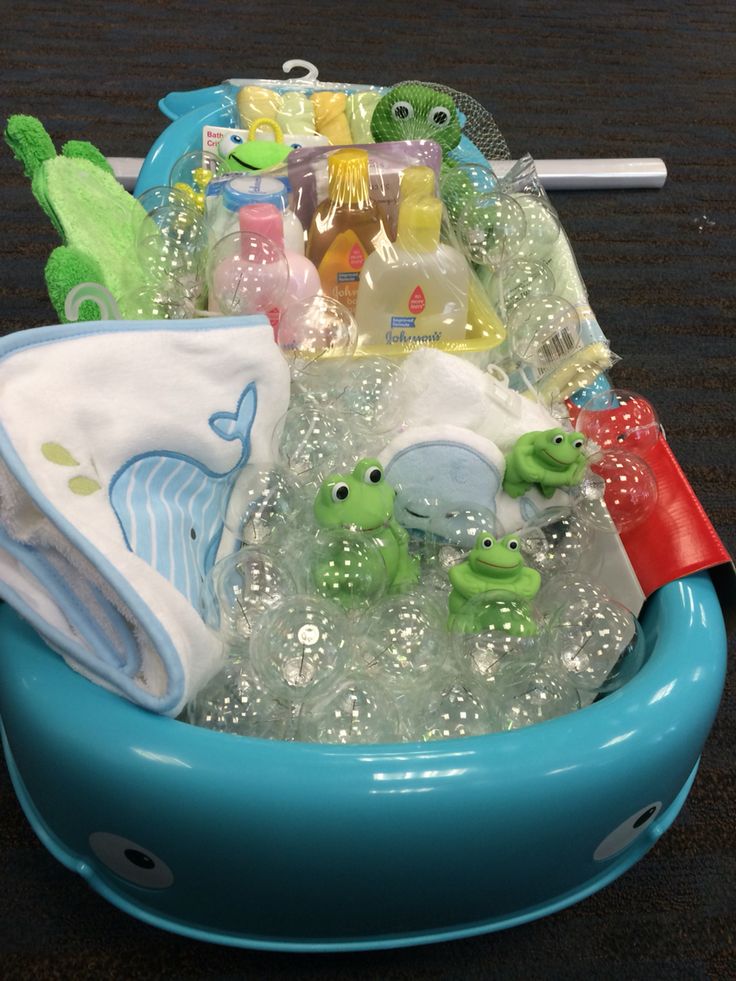 a blue bowl filled with baby items on top of a table