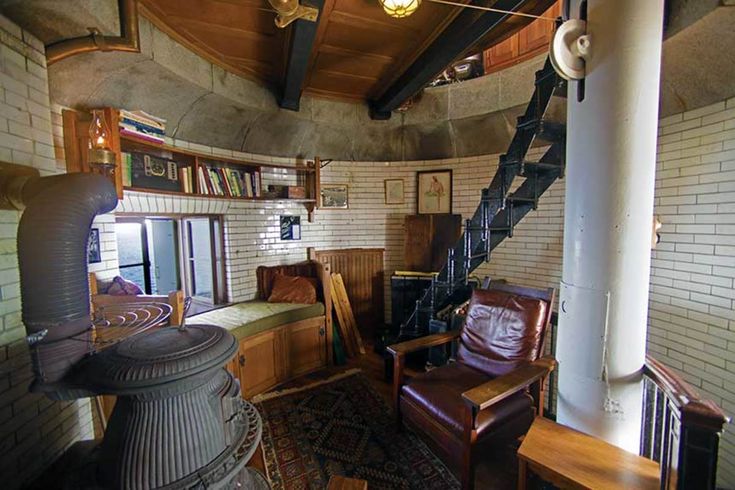 a living room filled with furniture and a spiral staircase