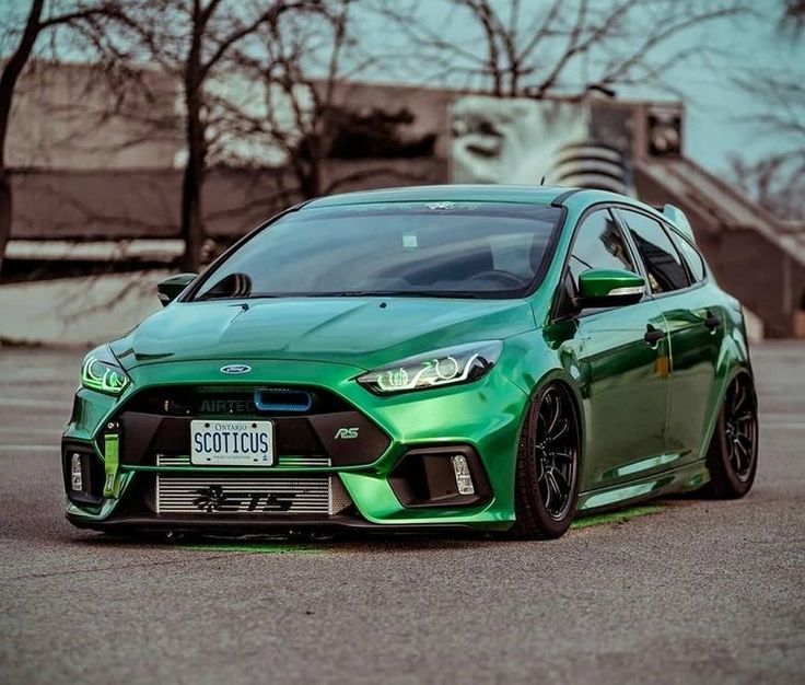 a green car parked in a parking lot