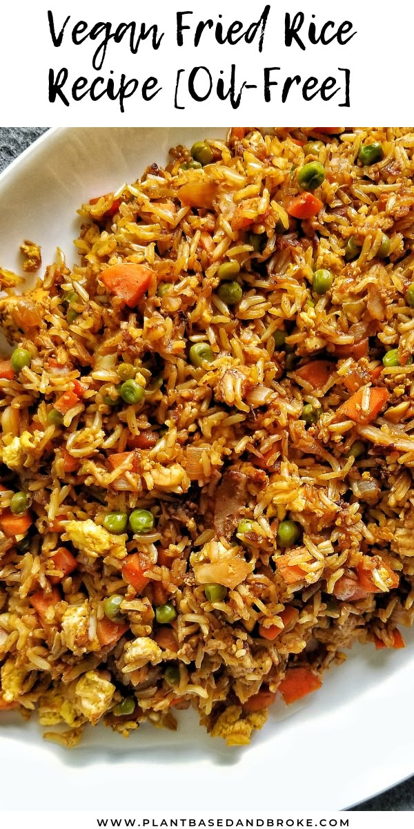 vegan fried rice with peas and carrots on a white plate