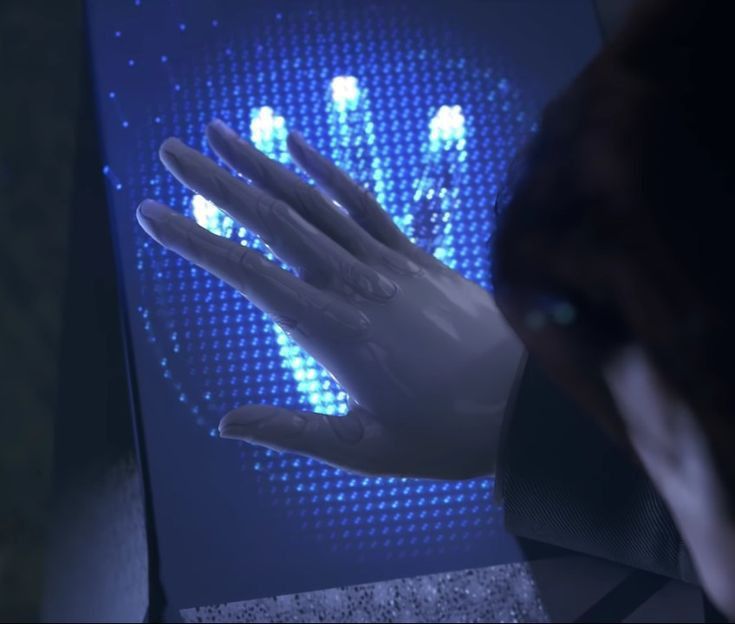 a person's hand is shown in front of a screen with lights on it