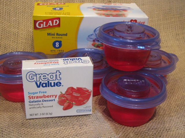 six plastic cups with strawberries and a carton of glaad milk