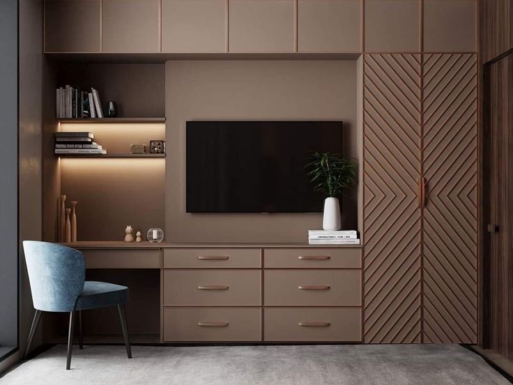 a living room with a television on the wall and a chair in front of it