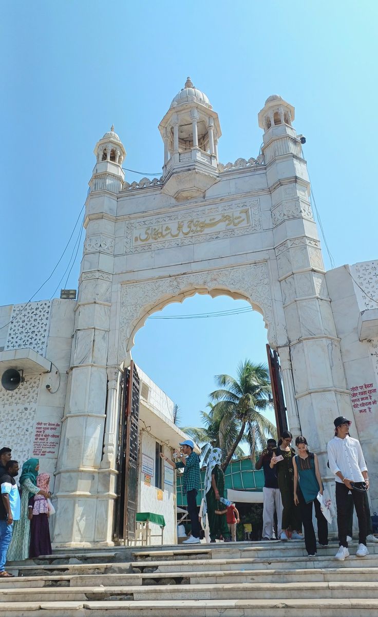 people are standing in front of an archway