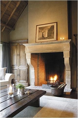 a living room filled with furniture and a fire place in the middle of a room