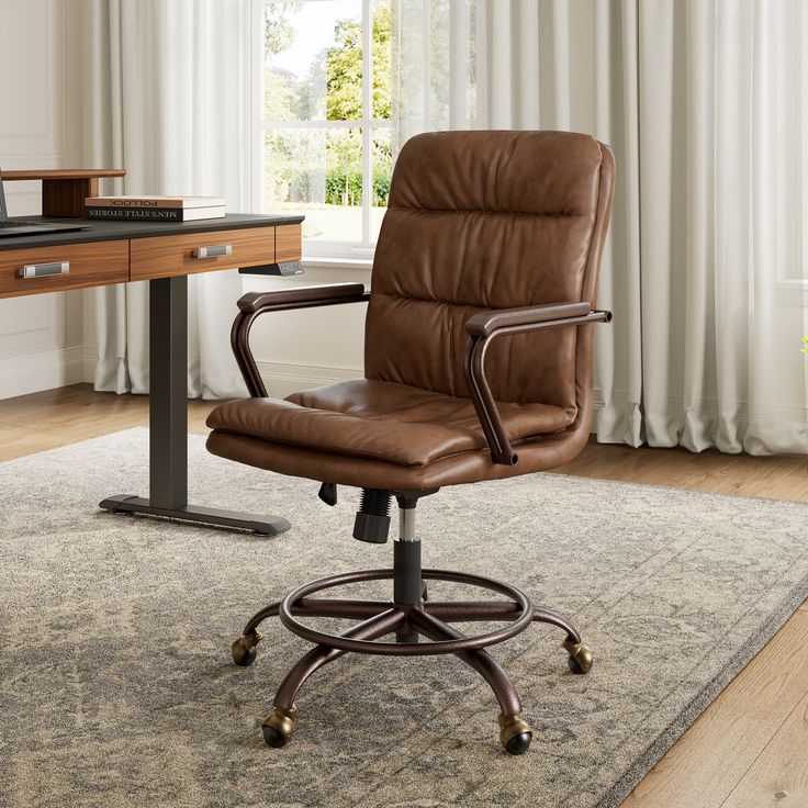 a brown leather office chair sitting in front of a desk with a computer on it