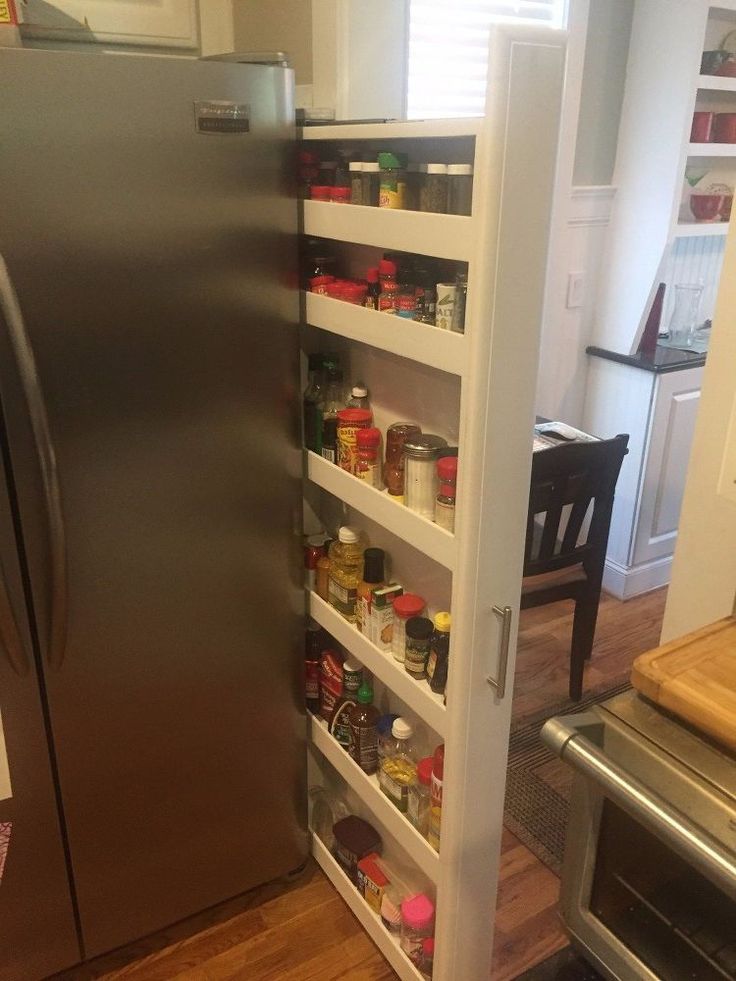 a refrigerator with shelves full of food and condiments in the door way, next to an oven