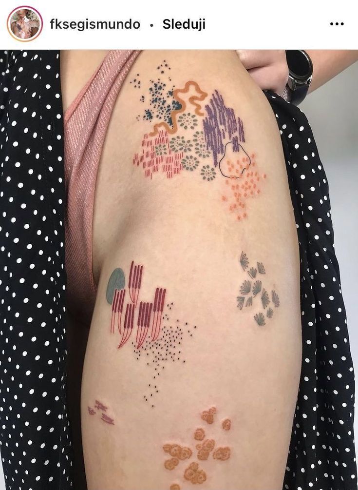 a woman's arm with tattoos on it and dots all over the entire body