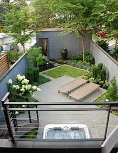 an outdoor hot tub in the middle of a garden