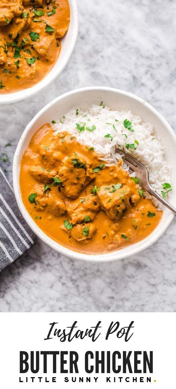 two bowls of butter chicken with rice and garnished with parsley on the side