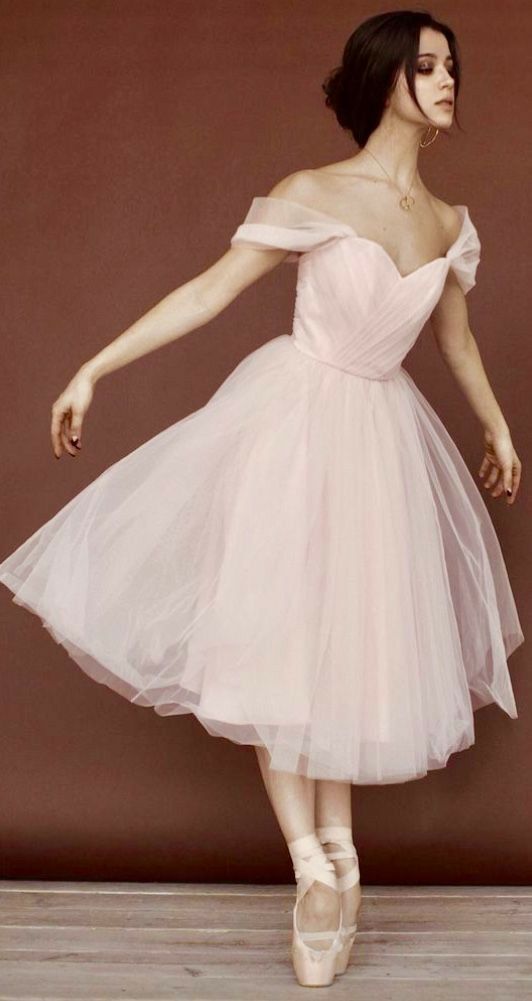 a woman in a pink dress is dancing