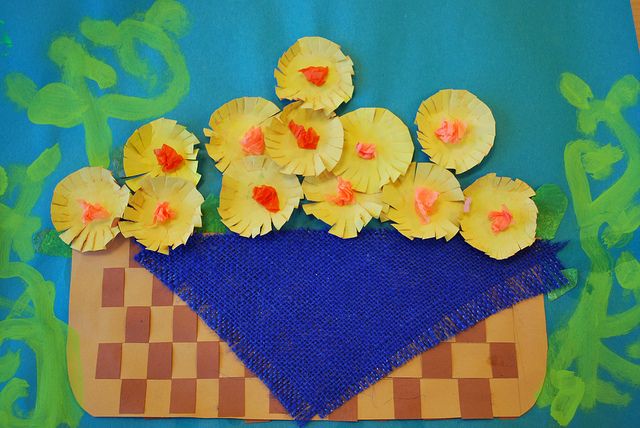 yellow flowers are placed on top of a blue piece of paper with a checkerboard design