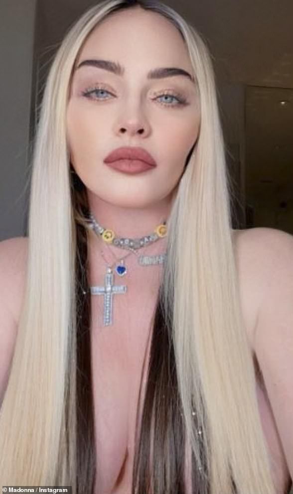 a woman with long blonde hair wearing a cross choker