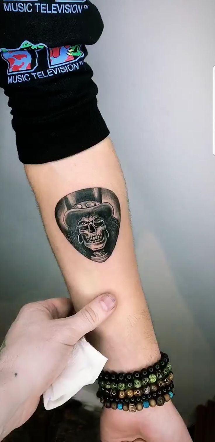 a person with a monkey tattoo on their arm