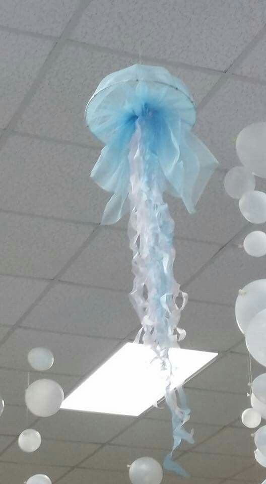 some white and blue balloons hanging from the ceiling