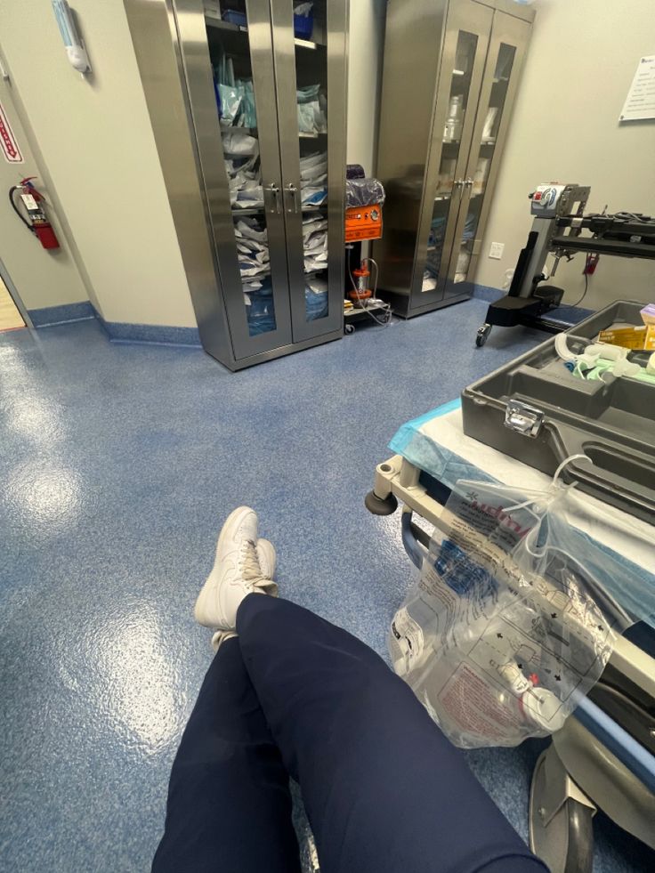 a person laying on the floor in a hospital room