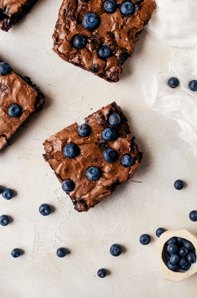 four brownies with blueberries and chocolate chips