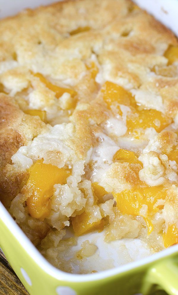 a casserole dish with peaches and rice in it on a wooden table