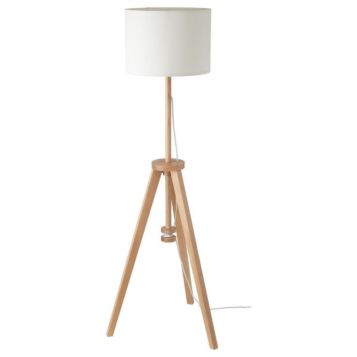 a wooden tripod floor lamp with a white shade