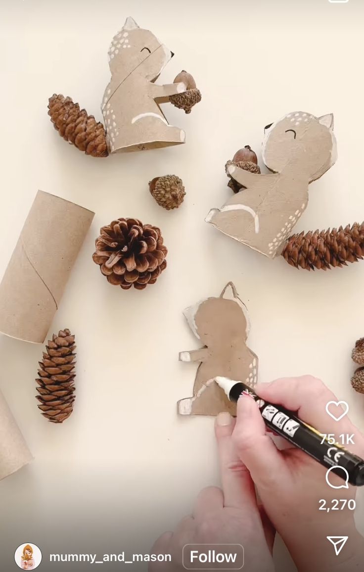 someone is making some paper animals out of pine cones