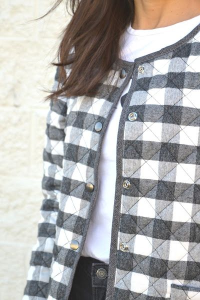 a woman wearing a black and white checkered jacket