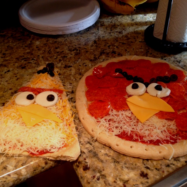 two pizzas decorated to look like angry birds