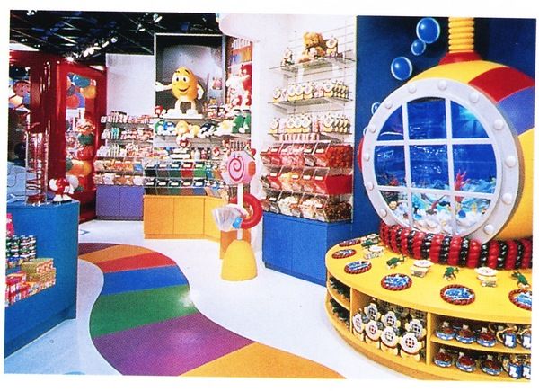 the inside of a toy store with lots of toys on display and in front of a circular window