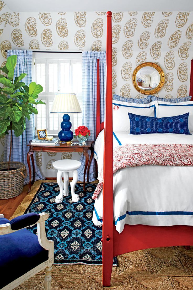 a bedroom with blue and red decor on the walls