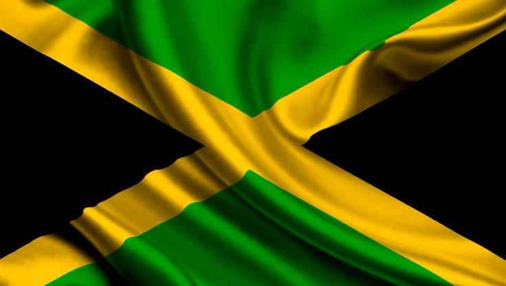 the flag of jamaica is waving in the wind