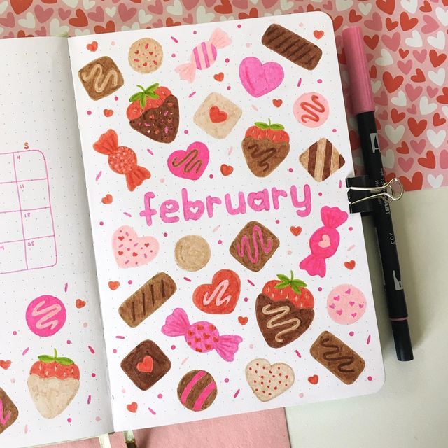 an open notebook with the word february written on it and lots of different candies