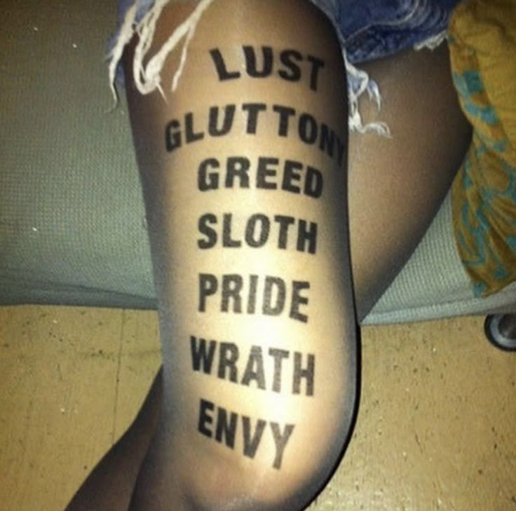 a person with tattoos on their legs that say, lust glutton greed sloth pride wray envy