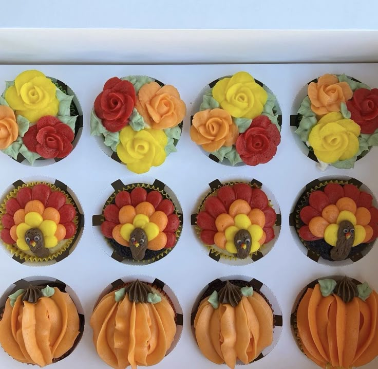 twelve cupcakes decorated with flowers and pumpkins