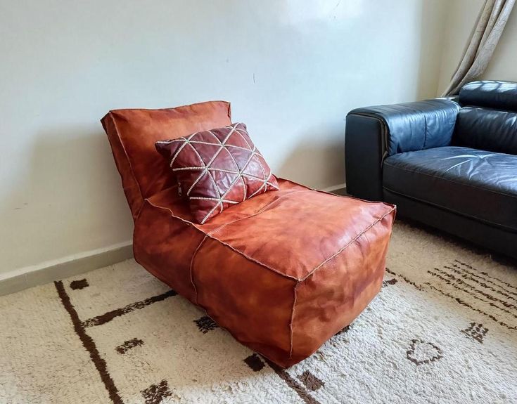 a brown leather chair sitting on top of a white rug