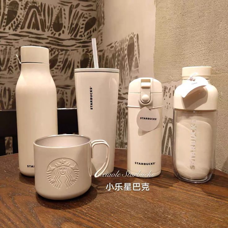 starbucks coffee cups and water bottles on a table