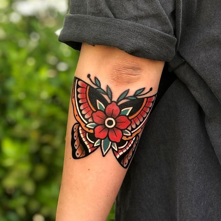 a person with a butterfly tattoo on their arm