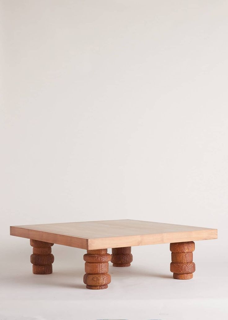 a wooden table sitting on top of a white floor