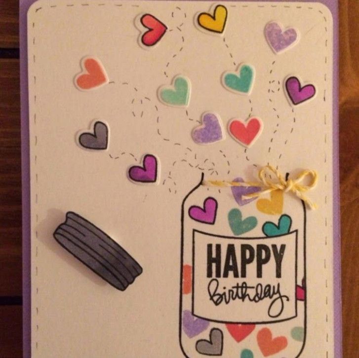 a happy birthday card with confetti and paper hearts in a jar on it