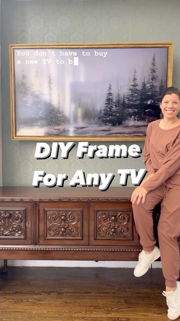 a woman sitting on top of a wooden bench in front of a wall mounted tv