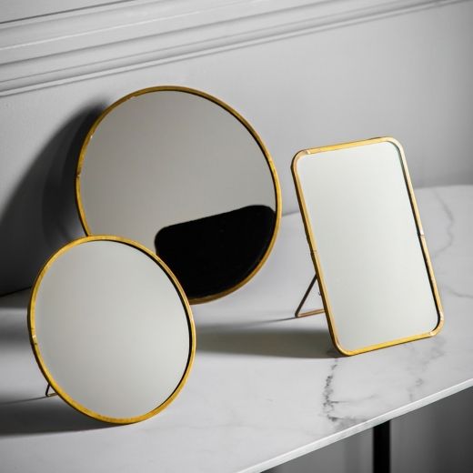 three mirrors sitting on top of a white counter