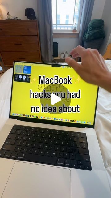 a person holding up a laptop computer with the words macbook hacks you had no idea about