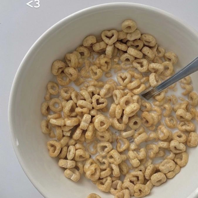 a bowl full of cereal with a spoon in it