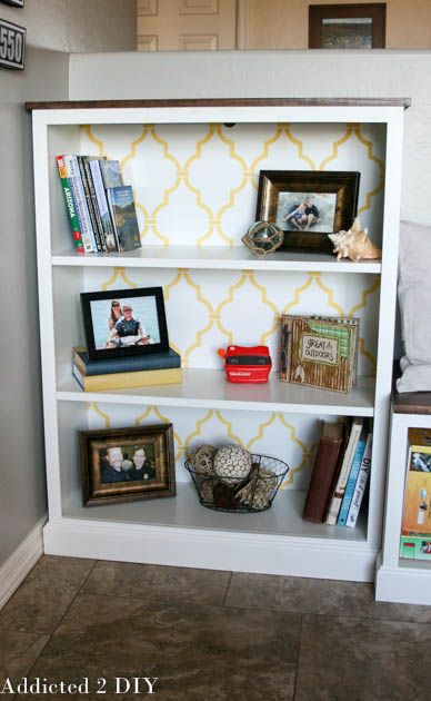 a white book shelf filled with books and pictures