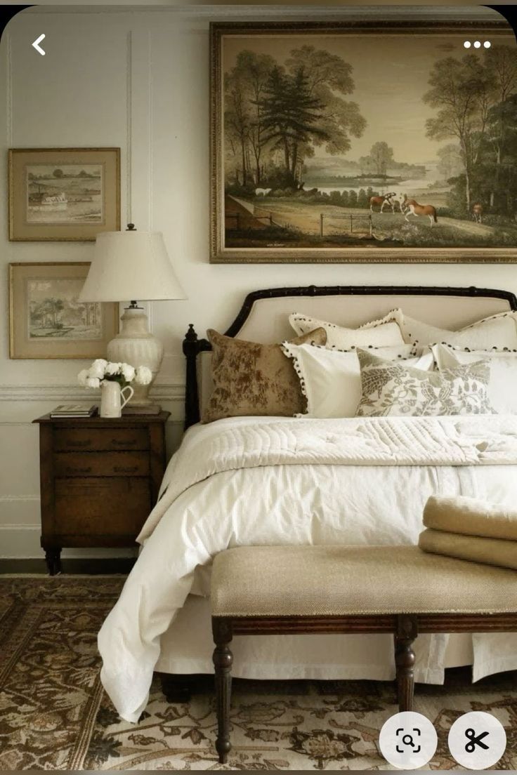 a large bed sitting under a painting in a bedroom