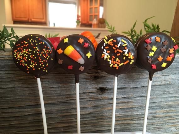 four chocolate cake pops with sprinkles on them