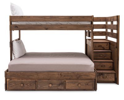 a bunk bed with drawers underneath it and a white pillow on the bottom one side